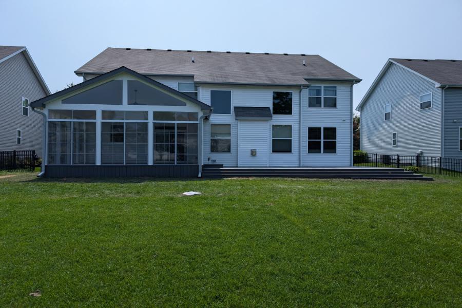 Screen Room with Trex® Deck Lineage Island Mist and Sunspace Panels with White Azek Wrapping Lake Villa